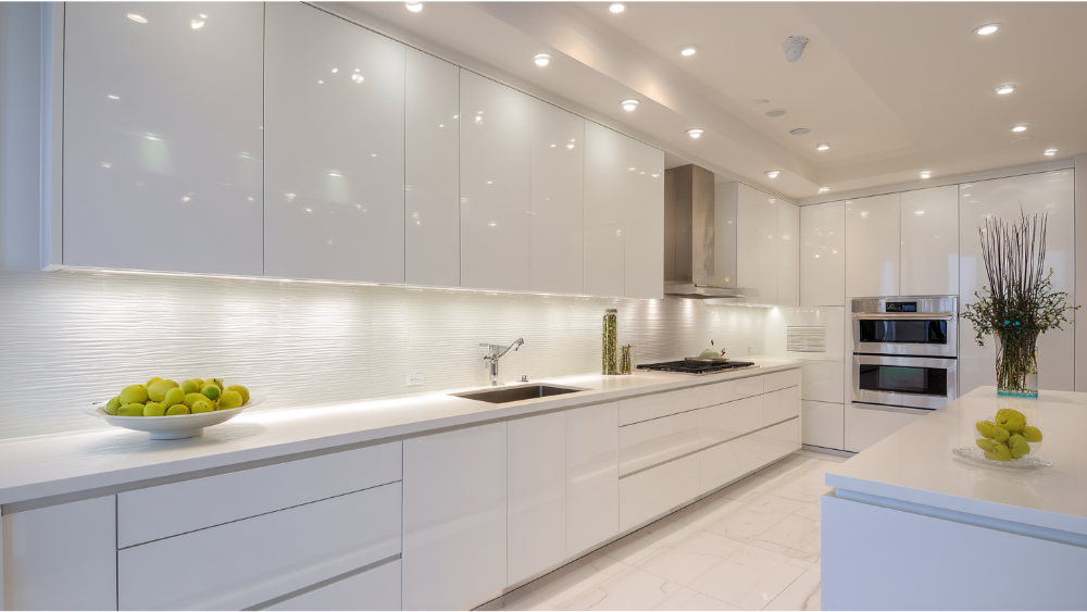 Contemporary Kitchen With High-Gloss White Cabinetry, Sleek Integrated Handles, Under-Cabinet Lighting, And Minimalist Décor.
