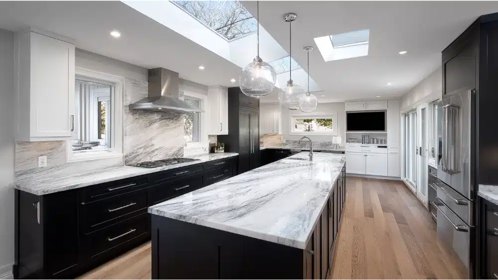 Two Tone Kitchen Cabinets: The 2025 Guide To A Bold, Stylish Kitchen Modern Kitchen With Black Lower Cabinets, White Uppers, Marble Countertops, And Skylights Bringing In Natural Light.