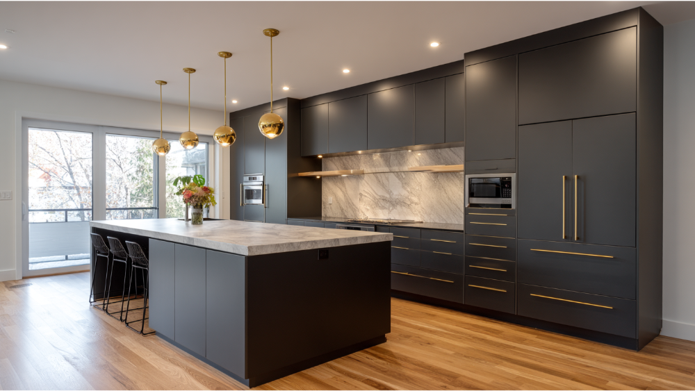 Modern Kitchen With Matte Black Flat-Panel Cabinets, Gold Hardware, Marble Backsplash, And A Large Island With Pendant Lighting.&Quot;